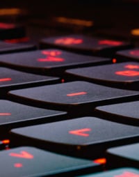 image of a laptop keyboard with glowing red letters on the keys